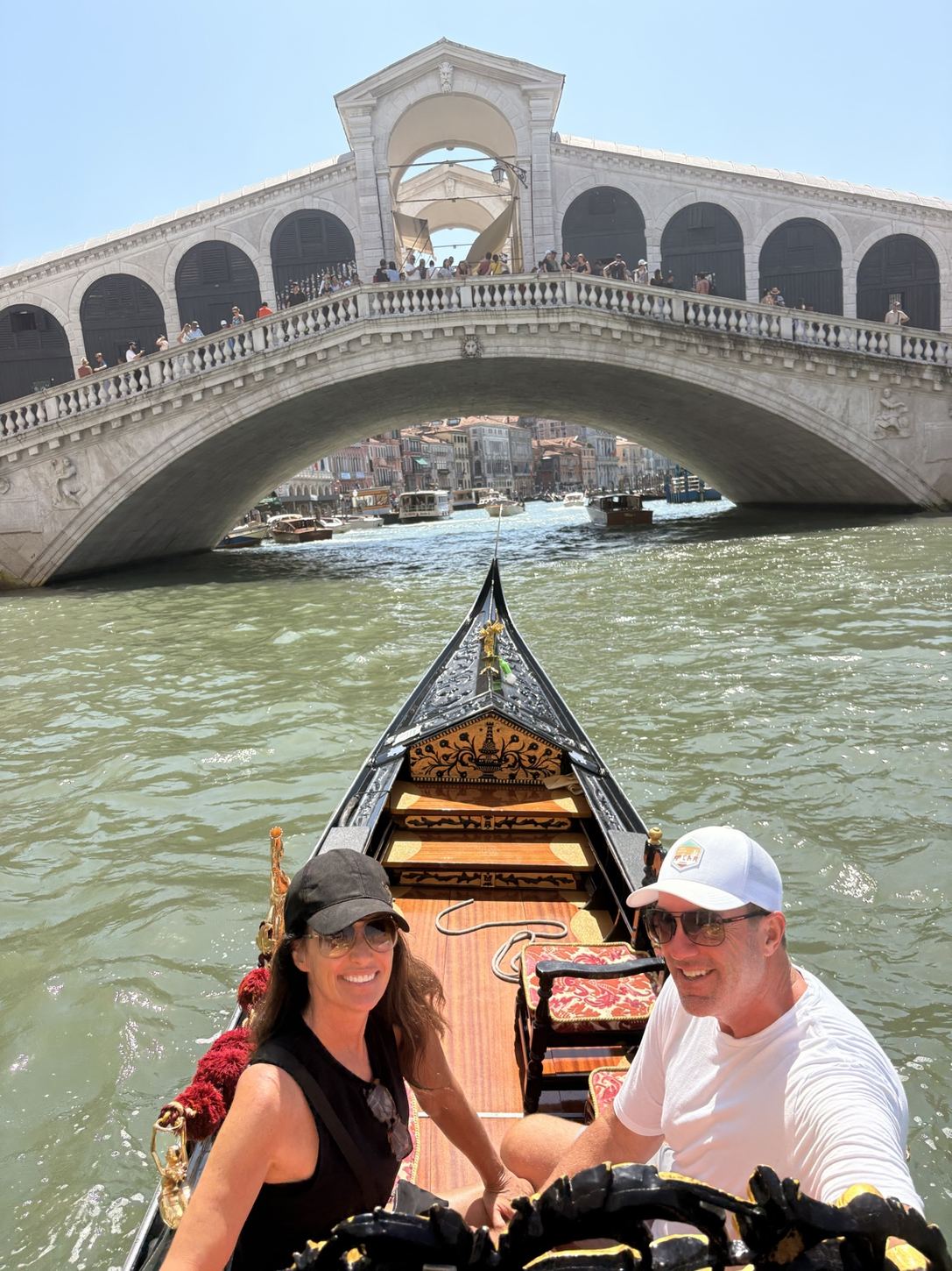 Jen and Brian on a gondola in Venice by the Rialto Bridge
